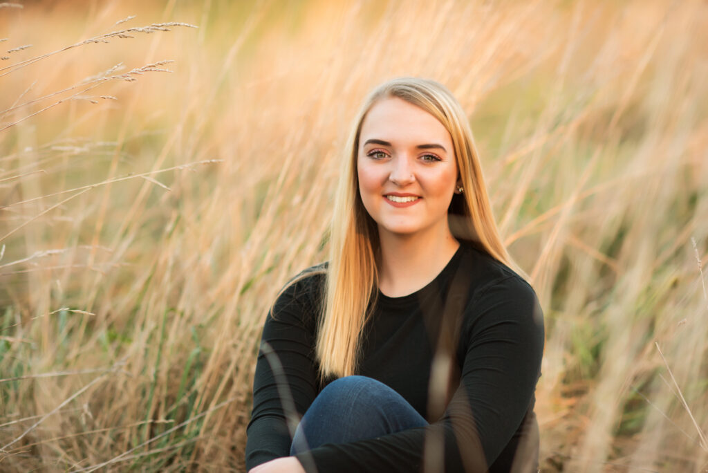 high school senior photography girl sitting in field